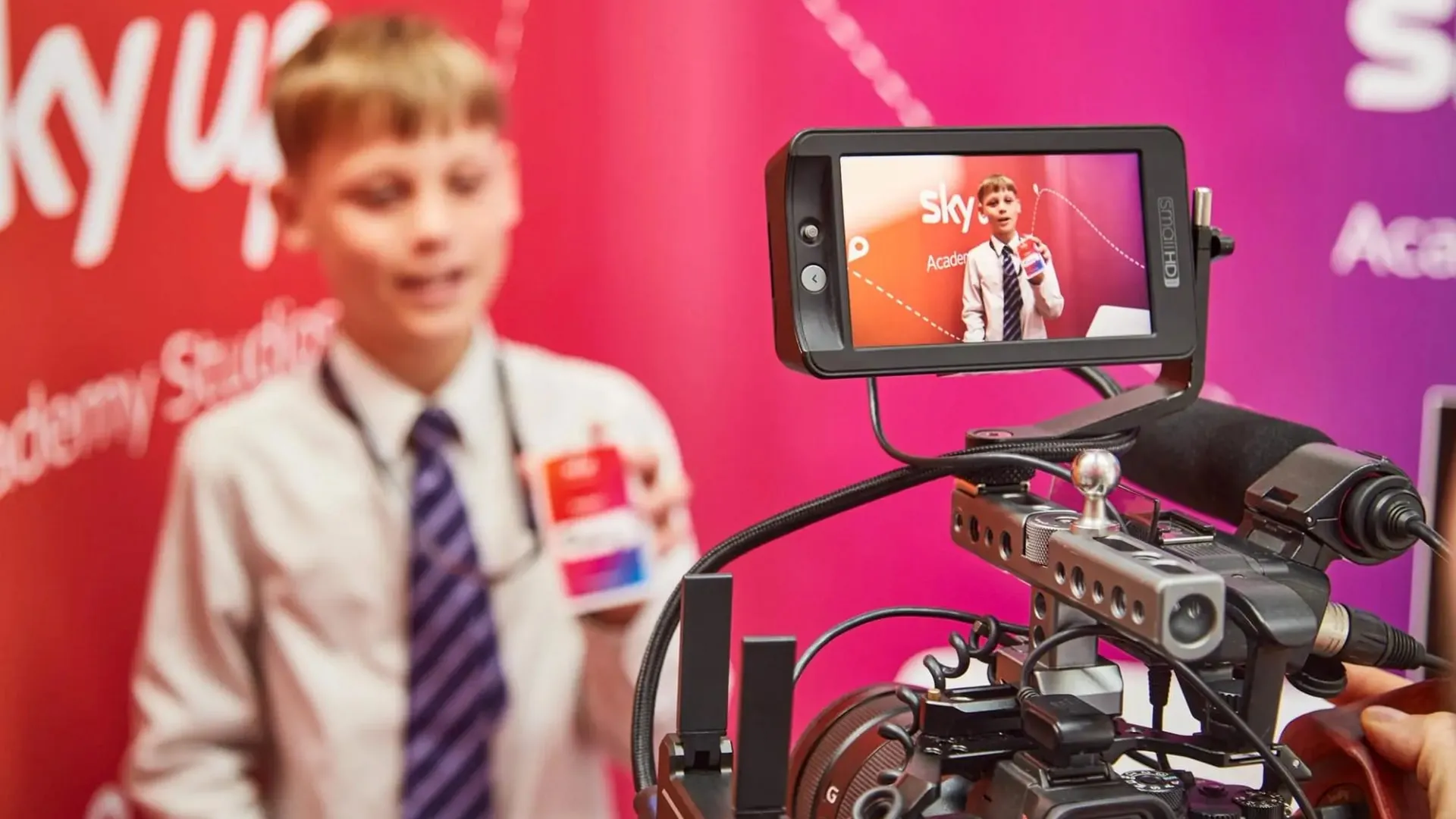 A student presenting to a broadcast camera in the studio