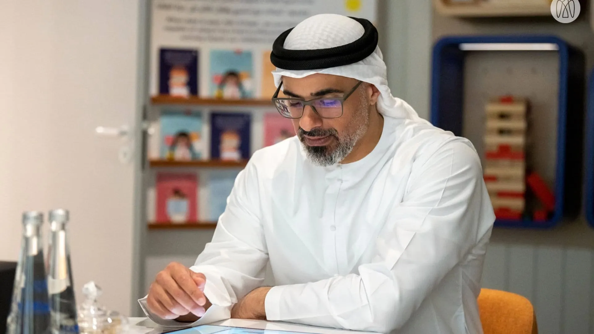 A visitor writing at the table inside the experience