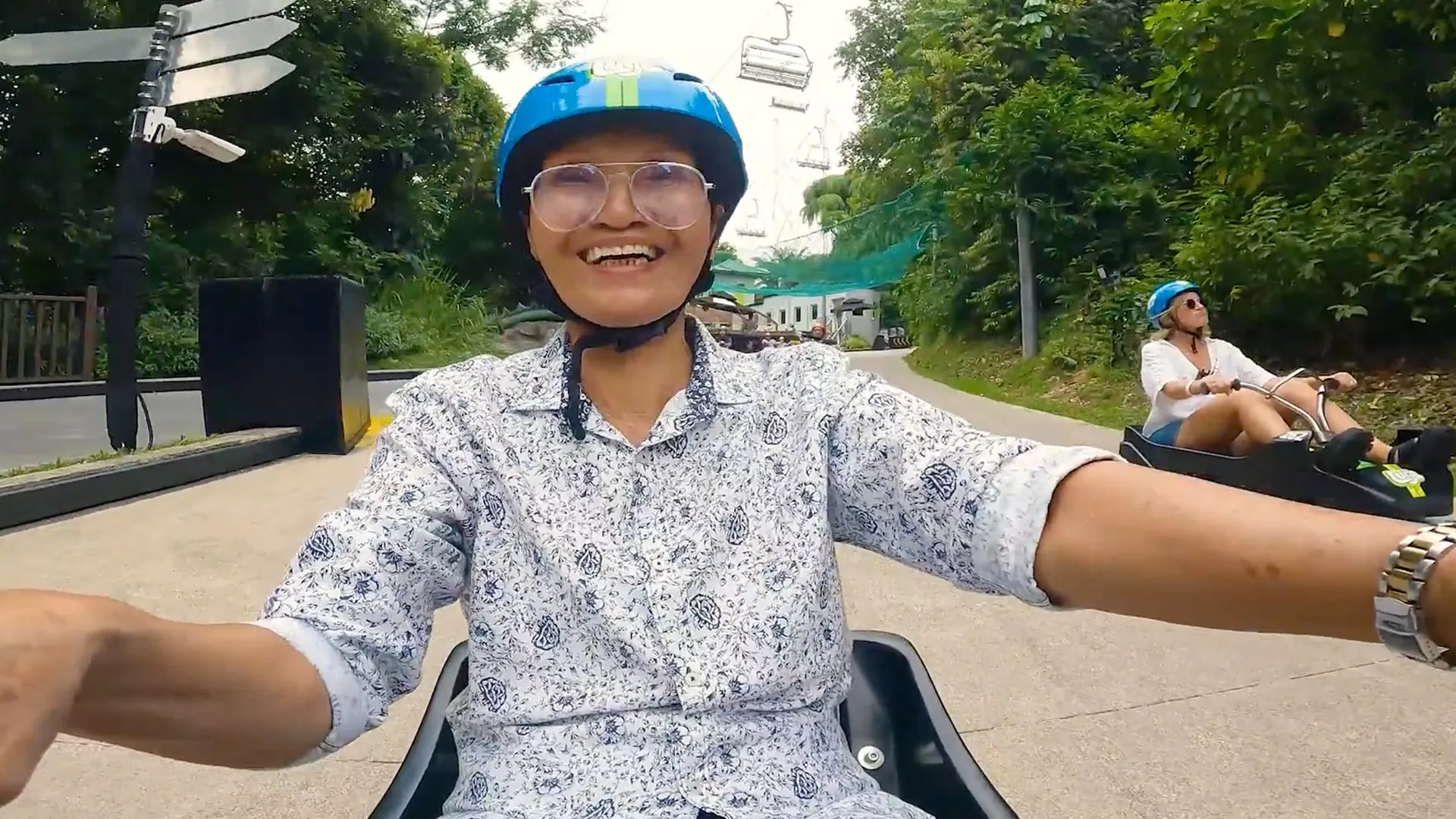 A grandmother laughing as she rides a luge