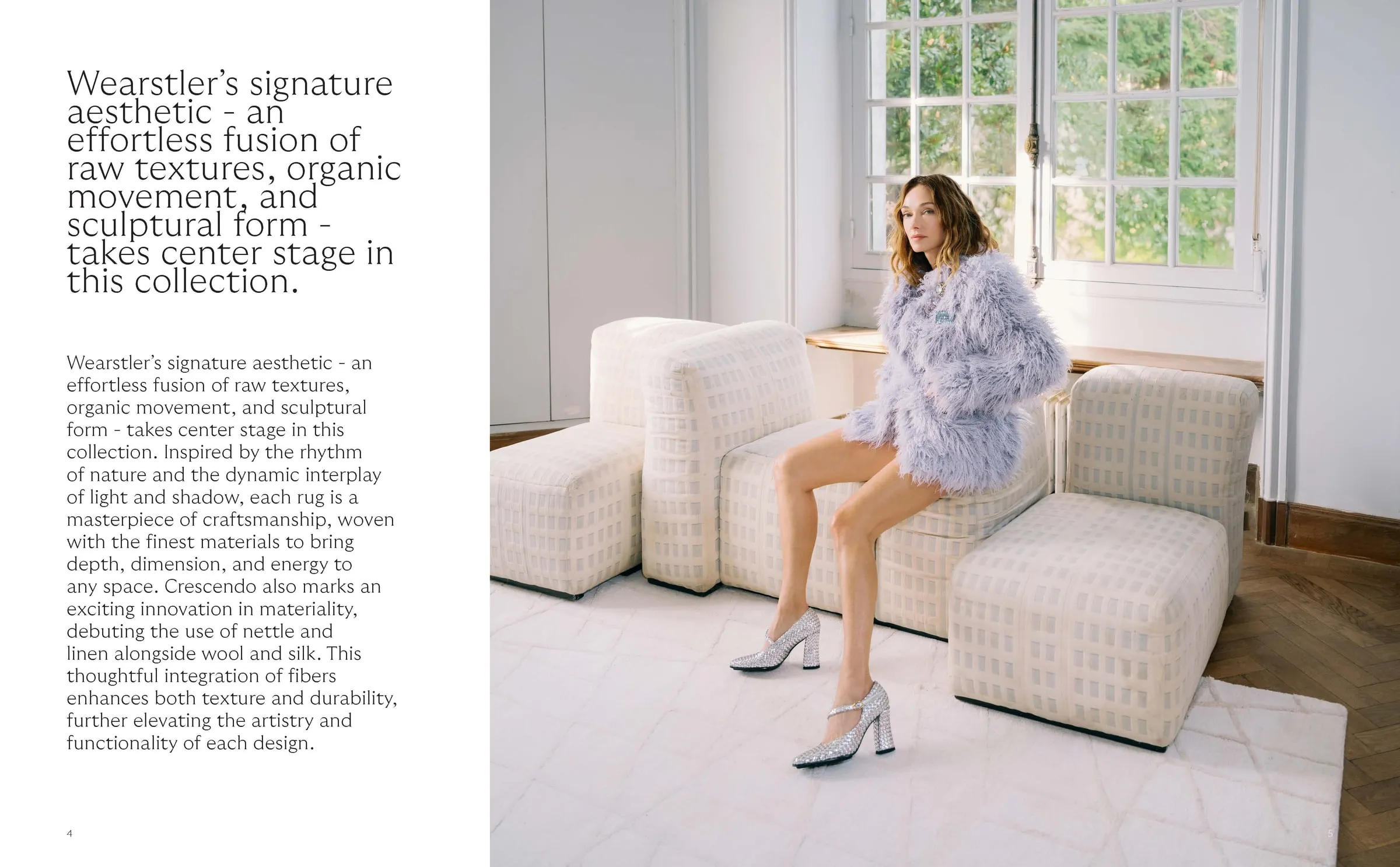 A model seated on a sculptural sofa above a textured rug