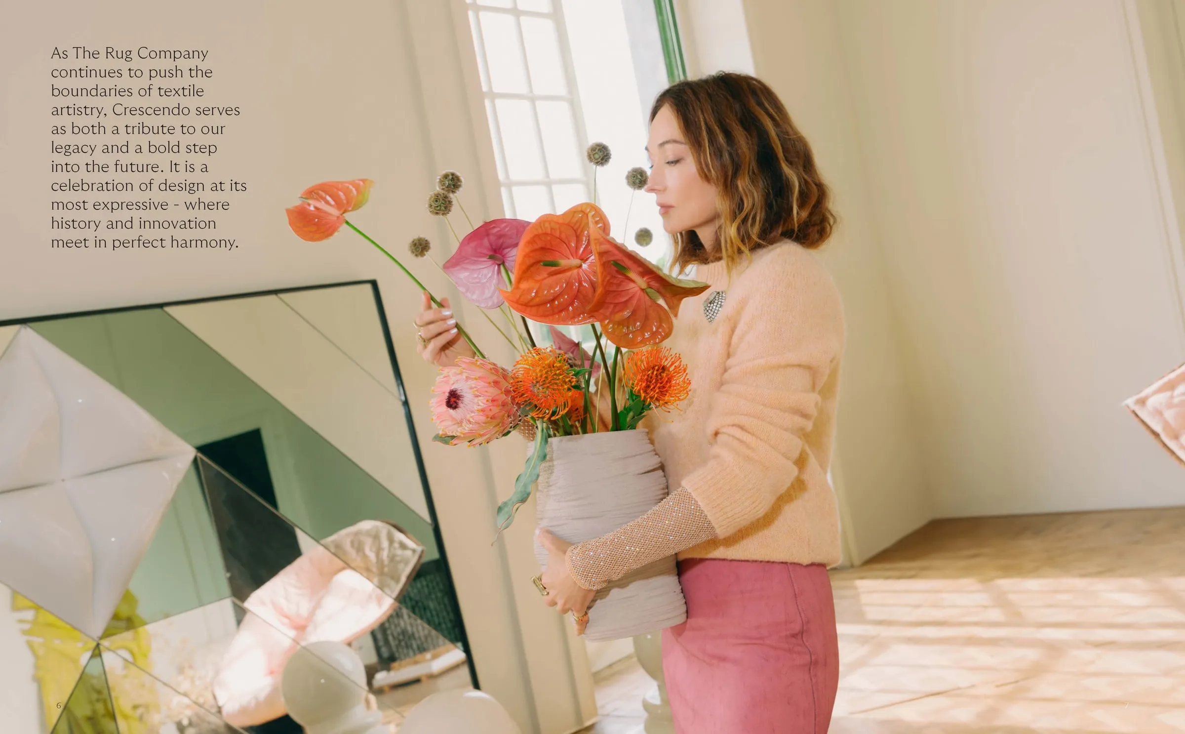 A model holding flowers beside a geometric artwork