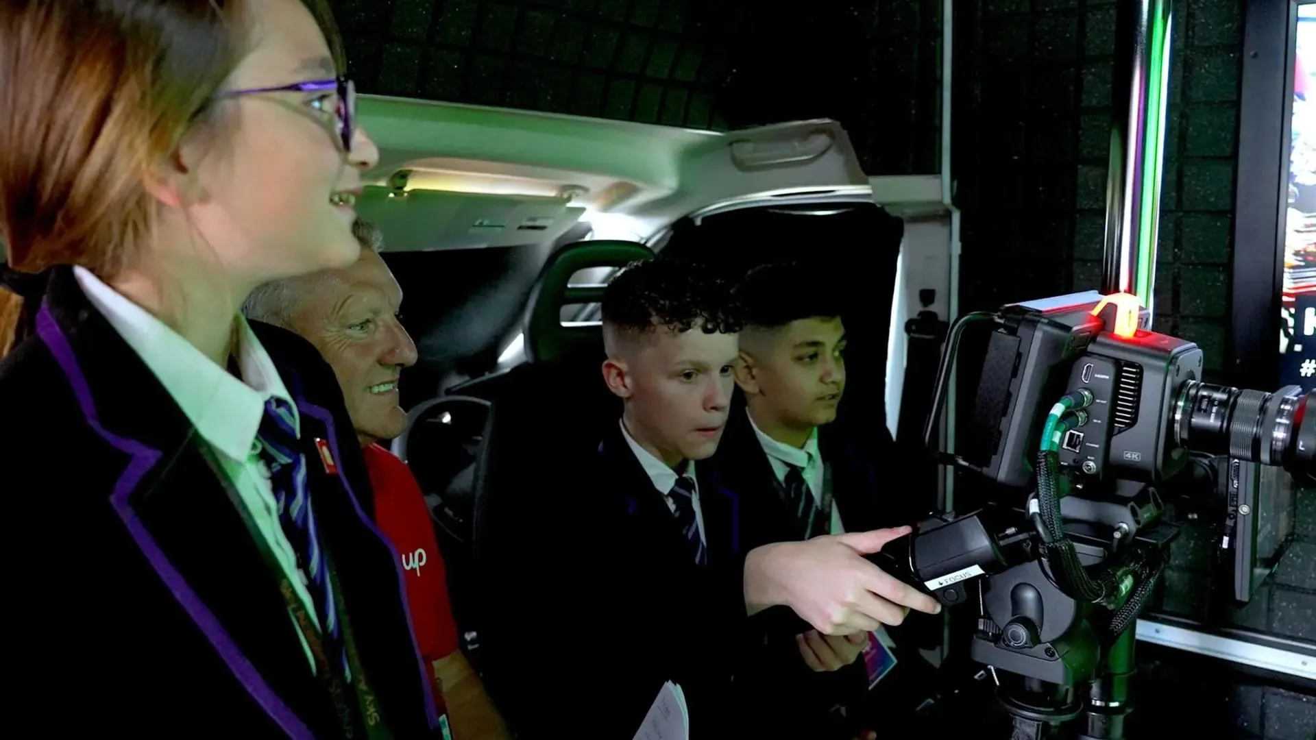 Students operating a broadcast camera together