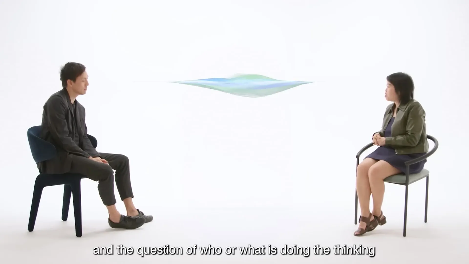 Two guests in conversation in the white studio