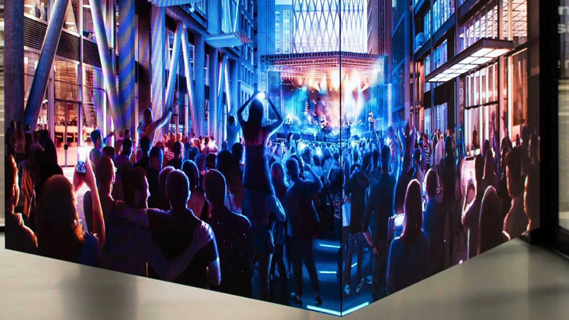 An immersive video wall showing a crowd at a night-time event