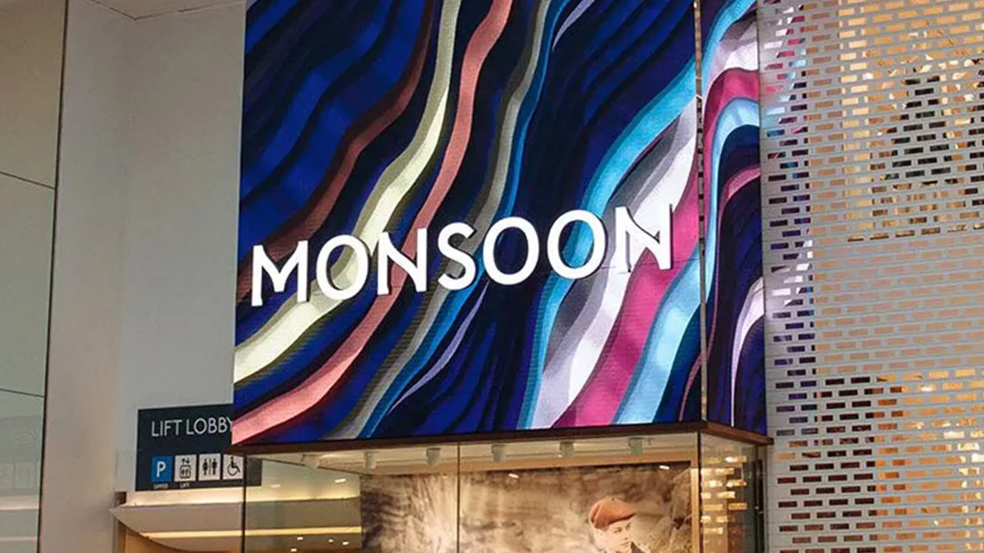 Swirling blue and pink generative artwork behind the Monsoon logo