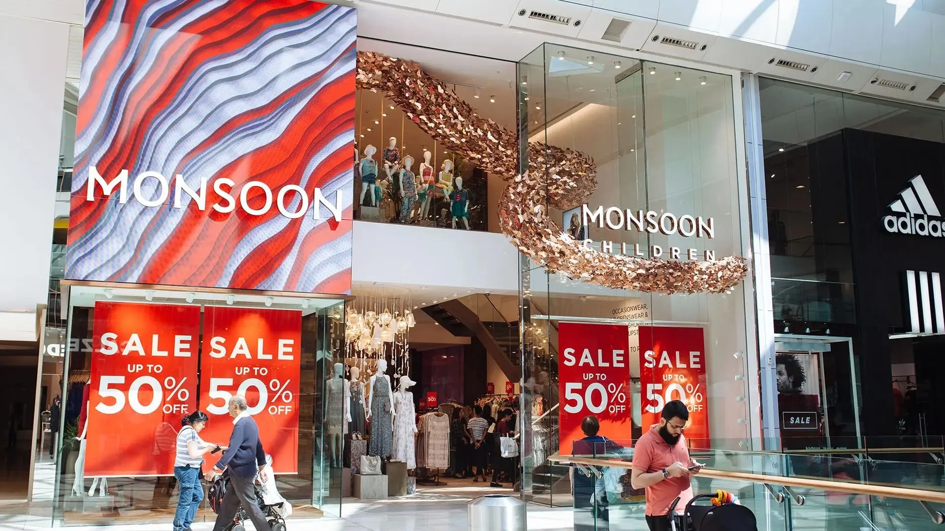 Red generative artwork on the store's digital façade