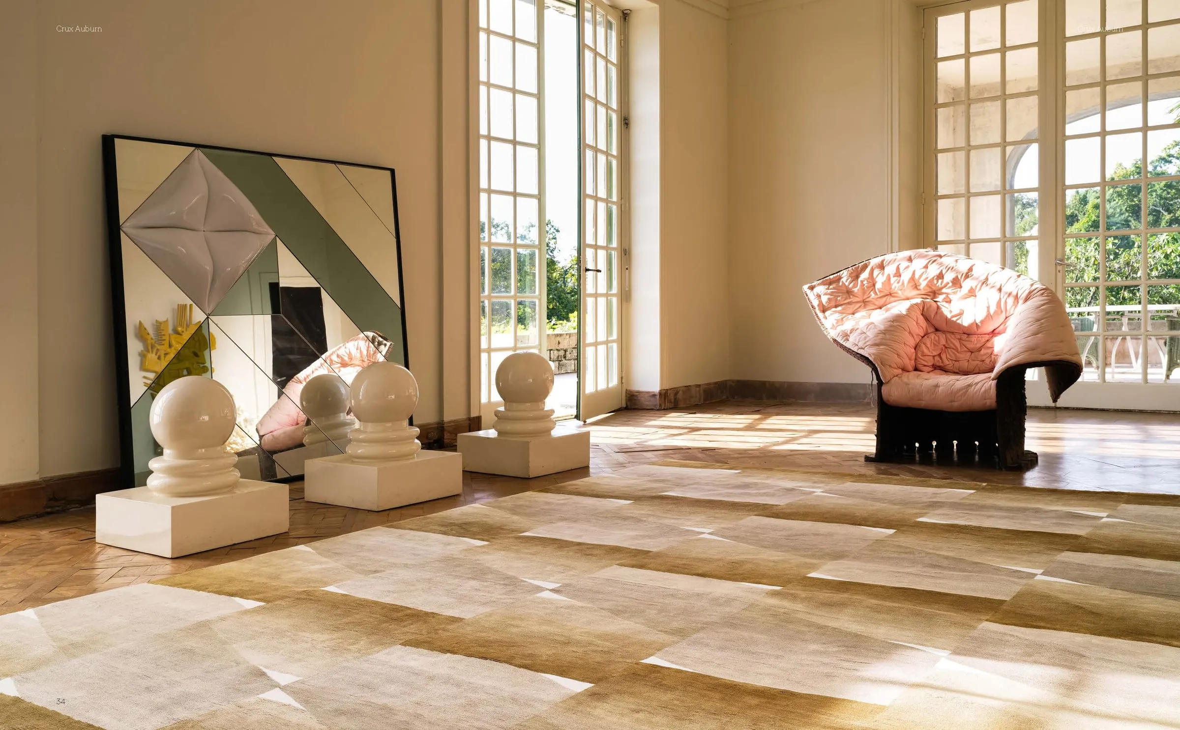 A sunlit room with a sculptural pink chair and geometric artwork