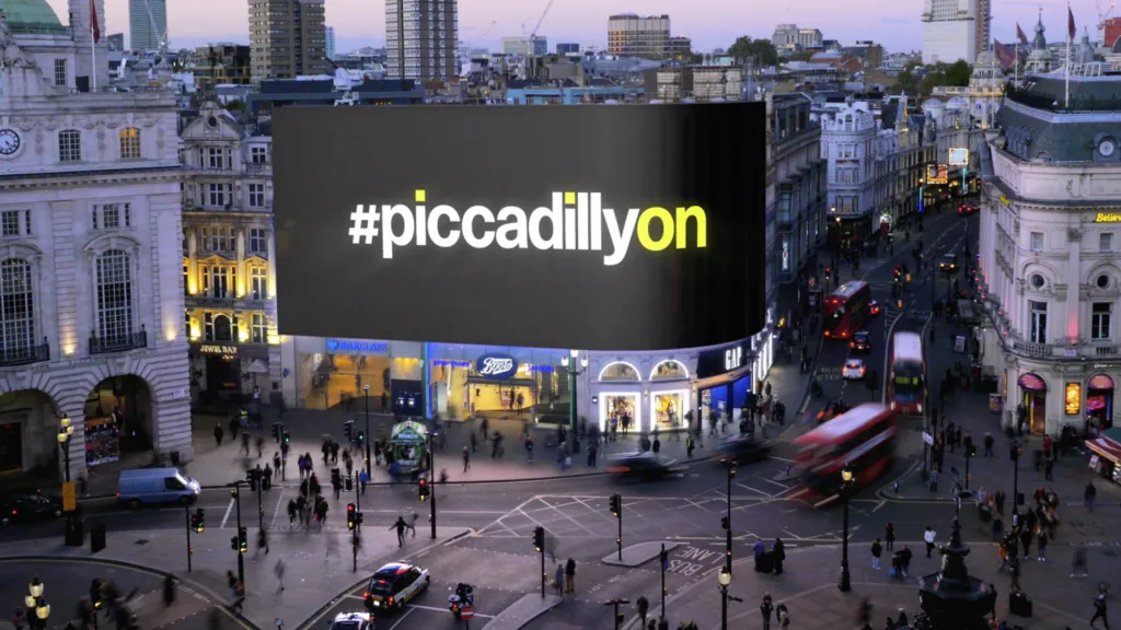 The #piccadillyon message on the Piccadilly Lights screen at dusk