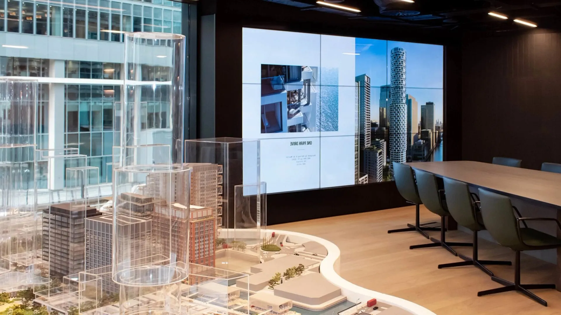 The marketing suite meeting room with a video wall and architectural model