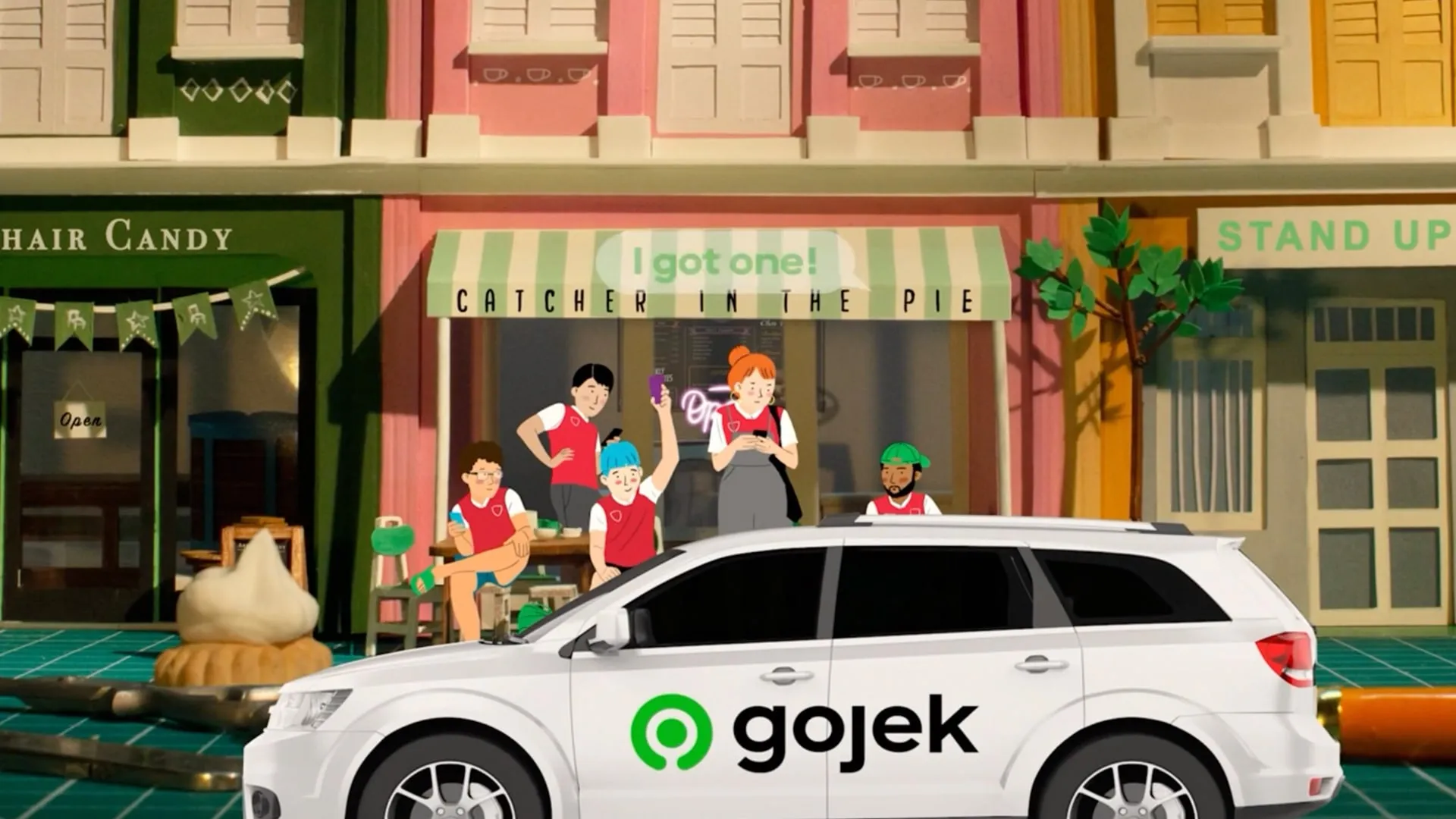 Animated characters celebrating beside a Gojek car on a colourful street