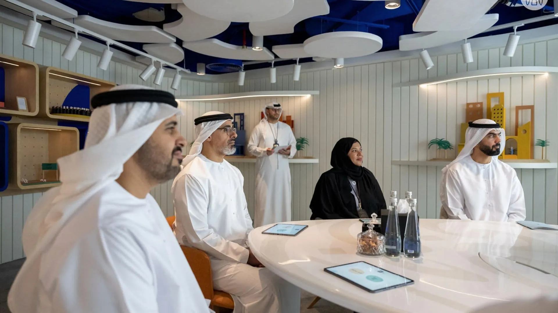 Policymakers seated around a table inside the immersive experience