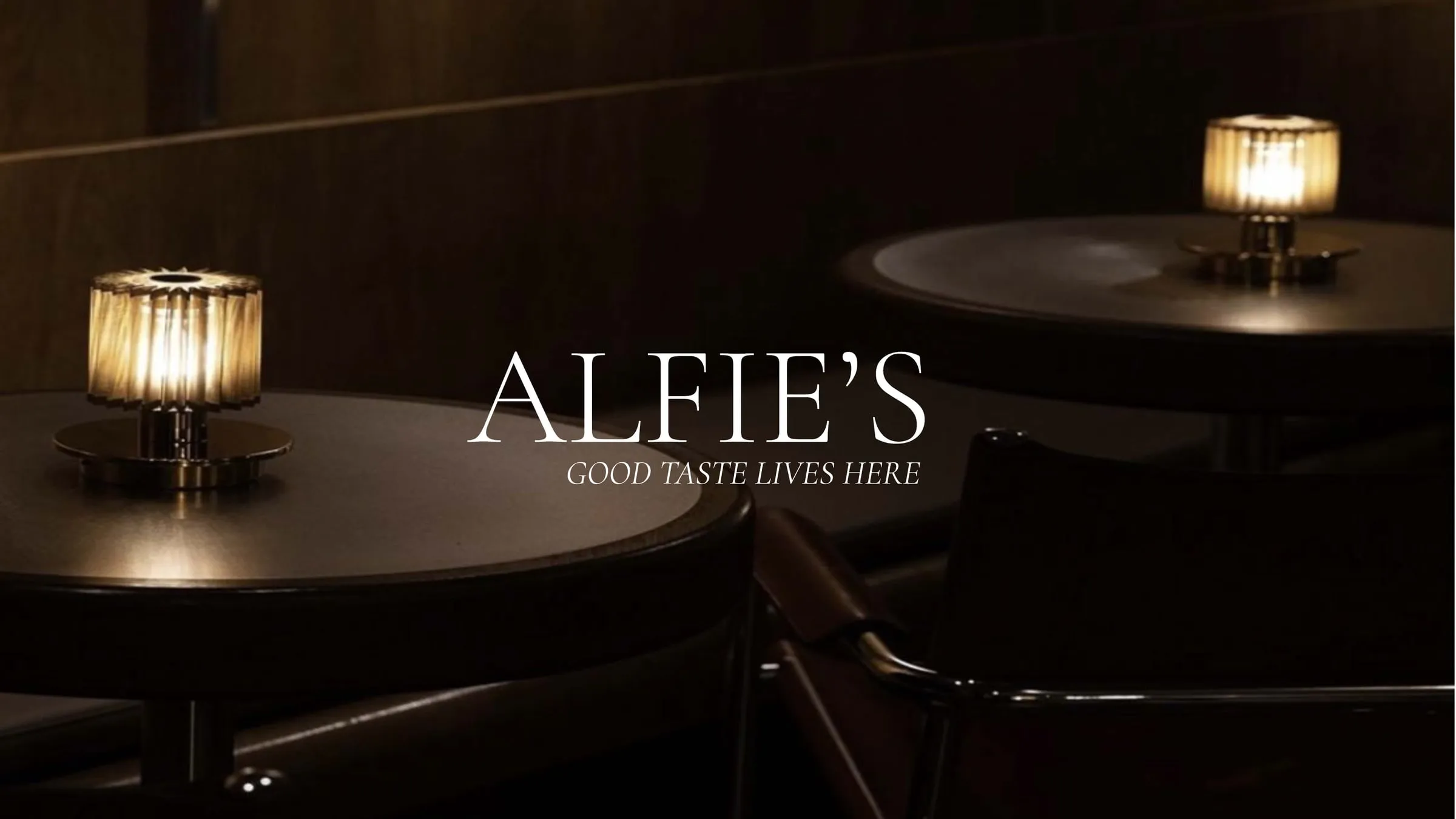 The Alfie's logo and 'Good taste lives here' strapline over a candlelit bar